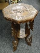 An Indian carved octagonal two-tier coffee table Condition reports are provided on request by