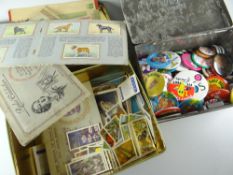 Two vintage tins containing late twentieth century pin badges & the other with cigarette cards