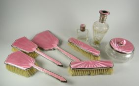 An eight-piece silver & pink Guilloche enamel dressing table set Condition reports are provided on