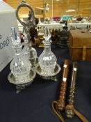 An EPNS three-bottle carrier with decanters & two wooden truncheons