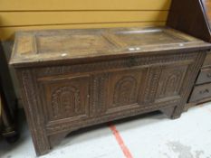 An early nineteenth century carved oak blanket chest, two of the three front panels converted to