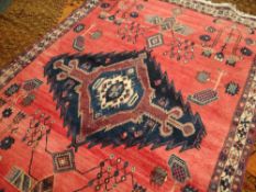 A rust ground Persian carpet with original labels, 212 x 161cms