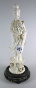 A blanc de chine figurine of Guanyin on a hardwood stand Condition reports are provided on request