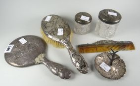 A part-silver dressing table set including ring tree, each with cherubic relief decoration Condition