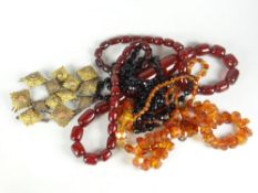 Three vintage bead necklaces including amber type together with a collection of brass regimental
