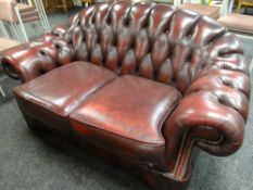 A two-seater burgundy leather Chesterfield-type settee Condition reports are provided on request