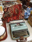 A vintage carpet bag & a cased typewriter Condition reports are provided on request by email only