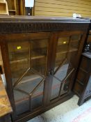 A good vintage linen-fold bookcase with two doors of panelled glass Condition reports are provided