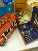 A cased part set of cutlery & a skittles game together with a model of an open top vintage bus