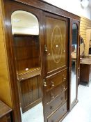 A vintage inlaid mahogany wardrobe with centre four-drawer chest, linen cupboard & matching dressing