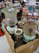 Two antique oil lamps with metal bases & milk glass reservoirs, together with a spare oil lamp shade