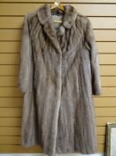 A full length mink fur coat with cover