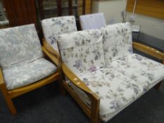 A mid-to-late twentieth century two-seater wooden framed settee & matching armchair, two further