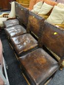 A set of four vintage buttoned leather dining chairs, a vintage elbow chair & another Condition