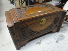 A vintage carved & stepped Oriental camphor wood chest Condition reports are provided on request