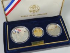 A cased set of three World Cup USA 1994 commemorative coins comprising gold five dollar, silver