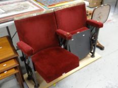 A pair of vintage numbered folding red upholstered cinema seats removed from a South Wales cinema
