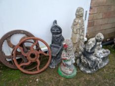 Four garden gnomes together with three metal wheels (?) Condition reports provided on request by
