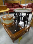 A brass Benares table on a carved stand together with a vintage footstool and a glass top coffee
