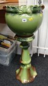 A green pottery planter on stand Condition reports provided on request by email for this auction