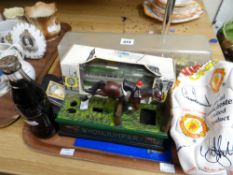 A reproduction show jumper money box, Manchester United merchandise football, a Royal State coach
