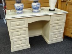 A modern cream coloured dressing table with glass top Condition reports provided on request by email