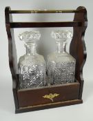 A two-bottle tantalus with bottles & stoppers Condition reports provided on request by email for
