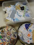 Two biscuit tins of loose stamps & tupperware box of the same Condition reports provided on