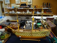 A rigged model of an HMS Victory battleship together with model-making tools & parts (behind counte