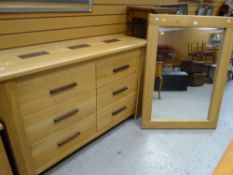 A suite of modern lightwood furniture comprising pair of bedside tables, chest / sideboard &