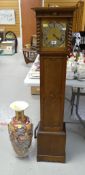 A vintage oak encased grandmother clock with brass dial & silver chapter ring together with a