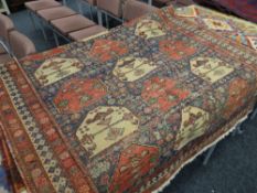 An old Persian rug, 187 x 127cms Condition reports provided on request by email for this auction