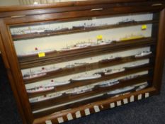 A wooden display case containing a display of ocean going vessel models Condition reports provided