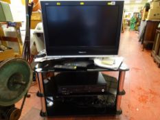 Panasonic LCD TV, a chrome and smoked glass stand and a Panasonic DMR-EZ 47v CD/video player E/T