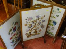 Two oak framed tapestry firescreens and a similar oak framed hanging