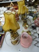 Three cherubic gilt decorated table lamps and others