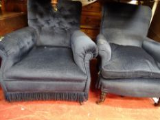 Two blue upholstered and ebonized armchairs on brass castors