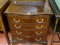 Reproduction mahogany bachelor's chest with brushing slide and serpentine front drawers