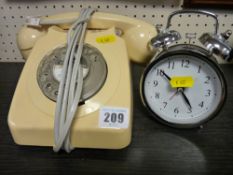 Vintage telephone and a modern alarm clock