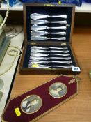 Cased quantity of pastry knives and a gilt metal framed pair of portrait miniatures
