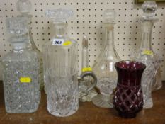 Collection of decanters with stoppers and other glassware