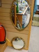 Gilt framed oval bevelled edge wall mirror and a circular gilt framed wall mirror