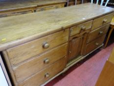 Victorian stripped pine dresser base of six opening drawers, small central drawer over a single