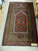 Old Baluchi prayer rug, multi-bordered deep colours with central red and blue ground panel, 148 x 88
