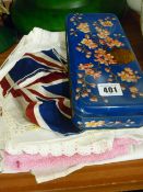 Small selection of vintage linen and a floral patterned biscuit tin and contents