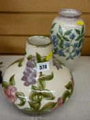 Two Cobridge stoneware vases in squat and baluster form, having painted floral decorations