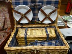 Wicker picnic basket with contents
