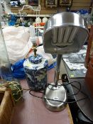 Modern chrome effect reading lamp and a blue and white table lamp in the Oriental style