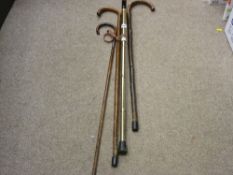 Three vintage walking sticks and one other