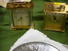 Two brass effect carriage clocks and a parcel of white metal placemats